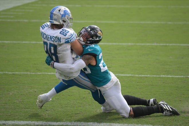 Lions tight end T.J. Hockenson (88) is tackled by Jaguars safety Josh Jones, right, during the second half.