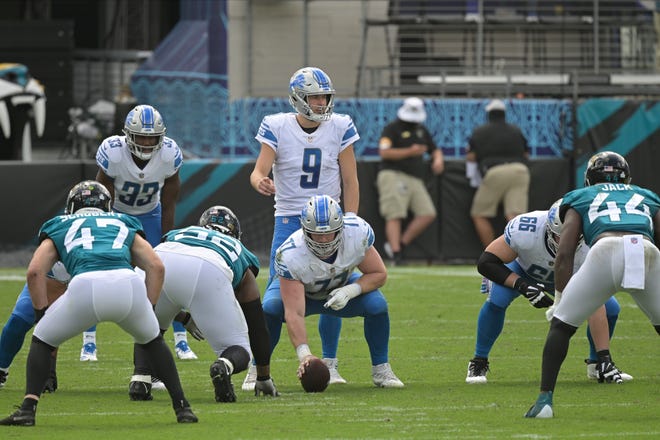 Lions quarterback Matthew Stafford calls signals at the line of scrimmage.
