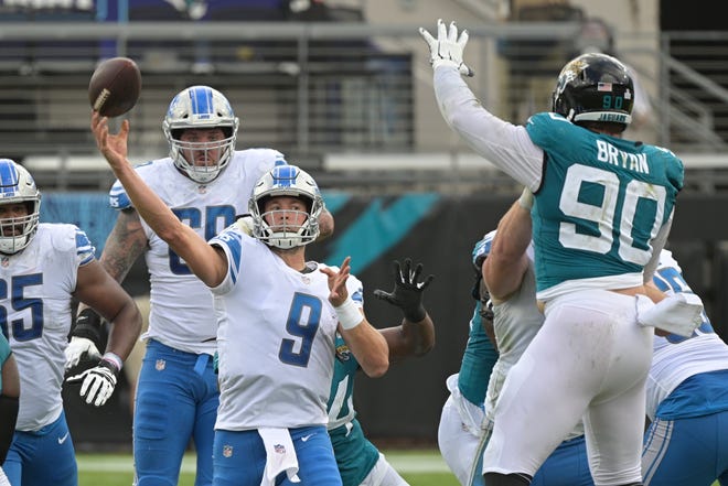 Lions quarterback Matthew Stafford throws a pass over Jaguars defensive tackle Taven Bryan.