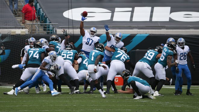 Jaguars place kicker Jon Brown (1) kicks a field goal against the Lions during the first half.