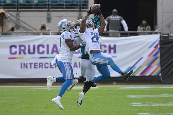 Lions safety Duron Harmon (26) intercepts a pass intended for wide receiver DJ Chark Jr. during the first half.