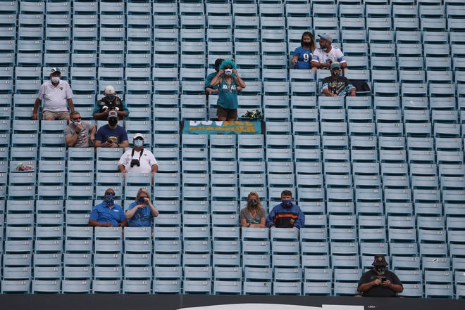 Socially distanced fans watch during the first half.