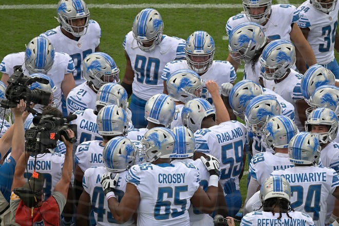 Lions players gather before the first half.