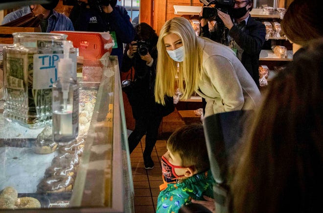Ivanka Trump asks a young customer what type of donuts he likes as she makes a surprise visit to Robinette’s Orchard in Grand Rapids.