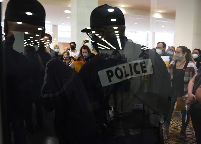 Detroit Police officers prevent MIGOP election challengers from entering the Central Counting Board hall at TCF Center in Detroit on November 4.