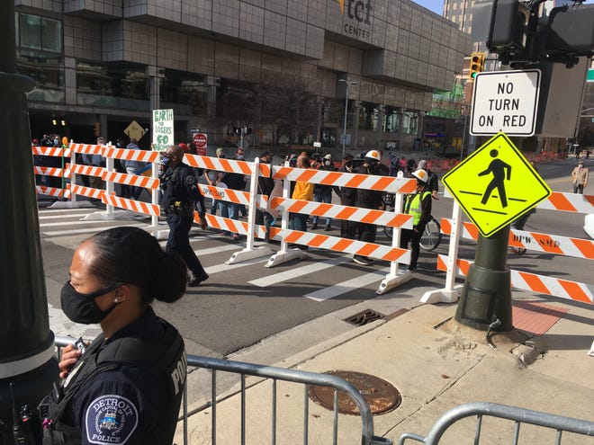 A group of counter protesters arrives at TCF Center in Detroit to combat a group of Trump supporters protesting the election count. Police erected a barrier to keep the two groups separated.