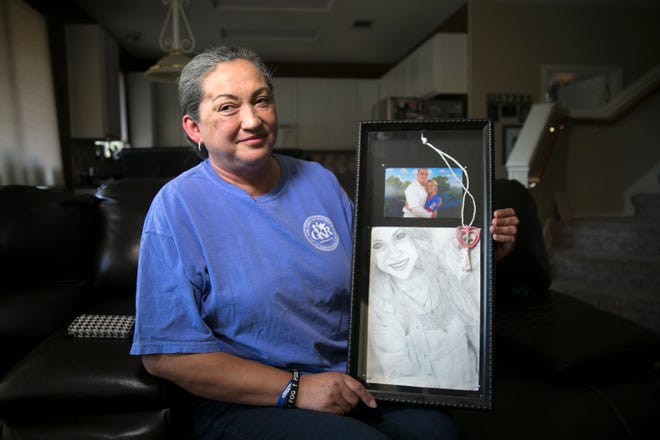 Rosa Kelley holds a photo that her son, Greg Kelley, drew while he was in prison.