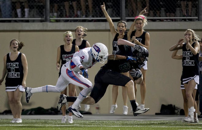 Leander High School defensive back Greg Kelley, left, chases down Cedar Park tight end Chad Whitehead in the first quarter of a game Friday, Sept. 28, 2012.