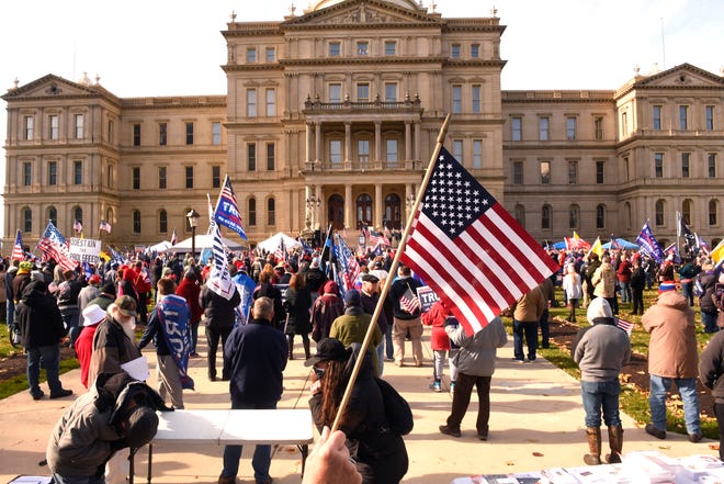 US flags fly as President Donald Trump supporters gather at the state Capitol Building  in Lansing for a "Stop the Steal" rally disputing the presidential voting Saturday, October 14, 2020.