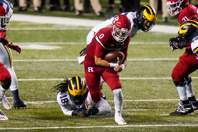 Rutgers' Noah Vedral (0) rushes past Michigan's Luiji Vilain (18) during the first half.