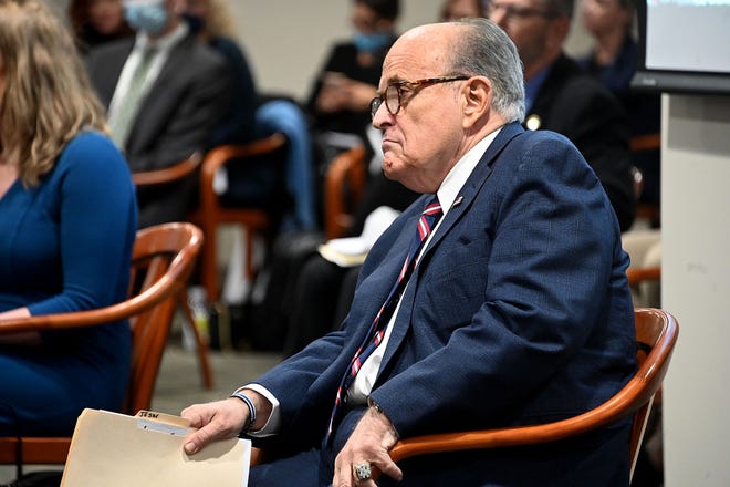 Rudy Giuliani waits before he testifies before the House Oversight Committee in Lansing