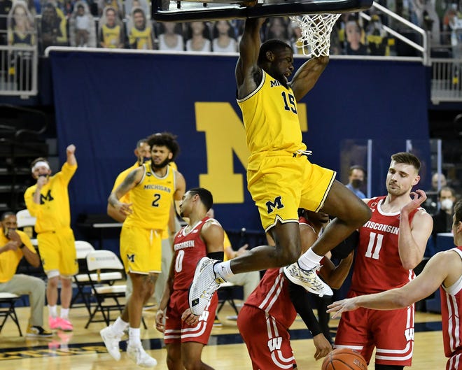Michigan guard Chaundee Brown (15) dunks in front of Wisconsin forward Micah Potter (11) in the second half.  Michigan vs Wisconsin at Crisler Center in Ann Arbor, Mich. on Jan. 12, 2021.  Michigan wins, 77-54.