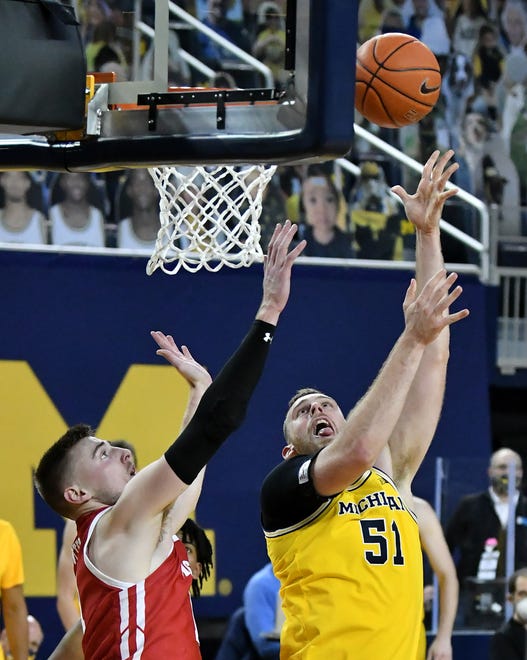 Michigan forward Austin Davis (51) puts up a shot with Wisconsin forward Micah Potter (11) defending in the second half.  Michigan vs Wisconsin at Crisler Center in Ann Arbor, Mich. on Jan. 12, 2021.  Michigan wins, 77-54.