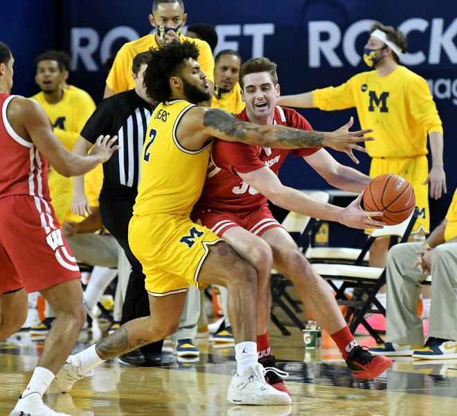 Michigan forward Isaiah Livers (2) guards Wisconsin forward Nate Reuvers (35) in the first half.