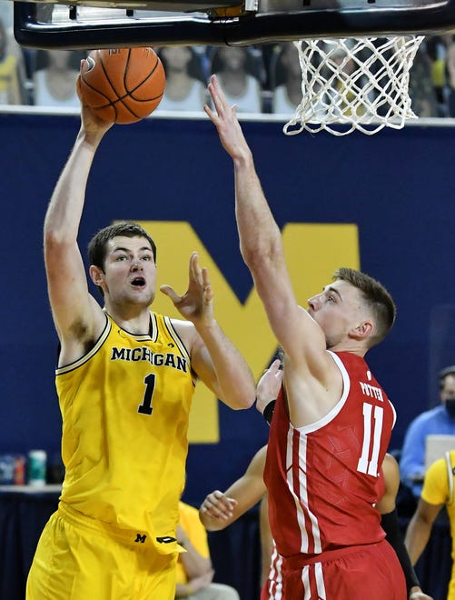 Michigan center Hunter Dickinson (1) shoots over Wisconsin forward Micah Potter (11) in the second half.
