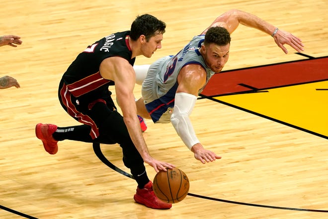Miami Heat guard Goran Dragic (7) and Detroit Pistons forward Blake Griffin (23) go after a loose ball during the first half of an NBA basketball game, Monday, Jan. 18, 2021, in Miami.