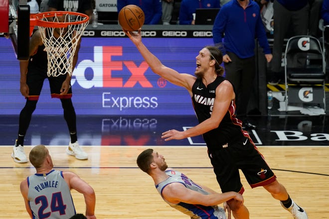 Miami Heat forward Kelly Olynyk (9) drives top the basket over Detroit Pistons guard Svi Mykhailiuk (19) during the second half. The Heat defeated the Pistons 113-107.