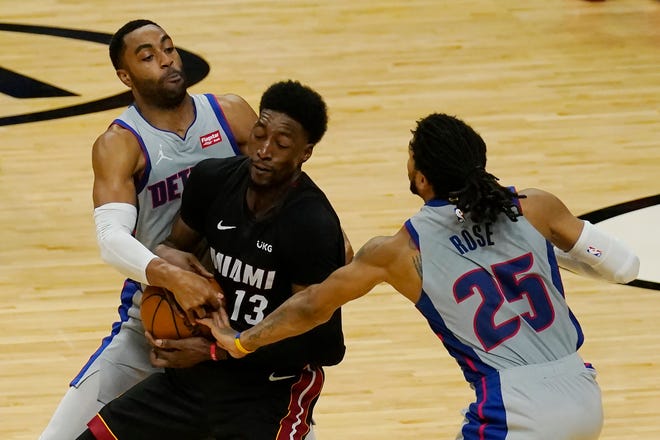 Detroit Pistons guards Wayne Ellington (8) and Derrick Rose (25) defend Miami Heat center Bam Adebayo (13) during the second half of an NBA basketball game, Monday, Jan. 18, 2021, in Miami.