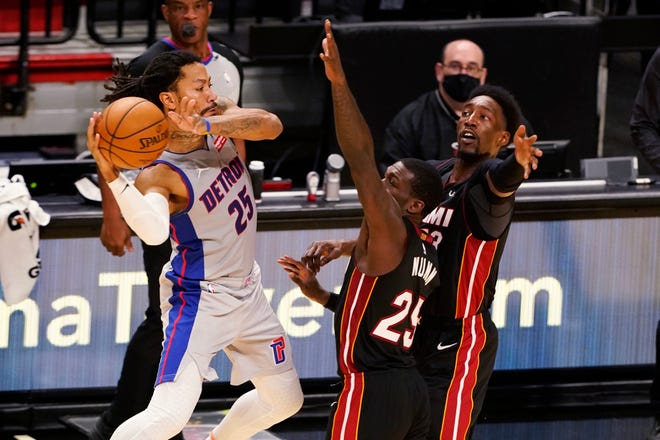 Miami Heat guard Kendrick Nunn (25) and center Bam Adebayo (13) attempt to block a pass by Detroit Pistons guard Derrick Rose (25) during the second half.
