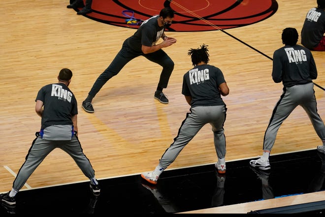 Miami Heat players wear warm-up T-shirts commemorating the Martin Luther King Jr. holiday.