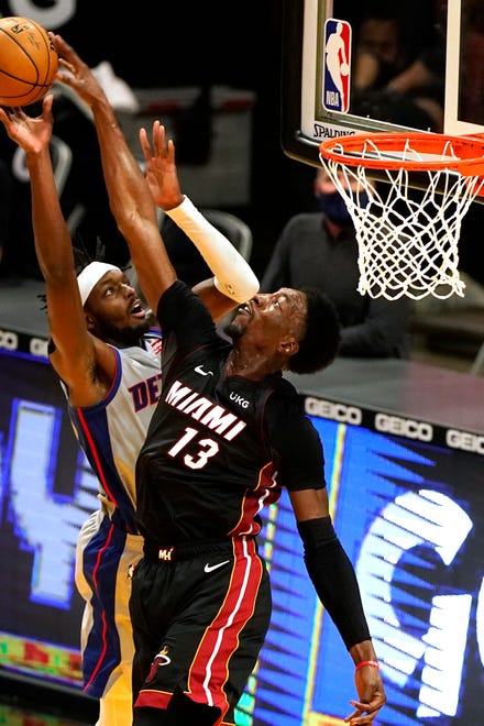 Miami Heat center Bam Adebayo (13) blocks a shot to the basket by Detroit Pistons forward Jerami Grant (9) during the second half of an NBA basketball game, Monday, Jan. 18, 2021, in Miami.