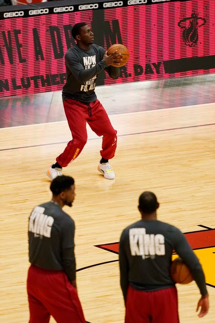 Detroit Pistons players wear warm-up T-shirts commemorating the Martin Luther King Jr. holiday.