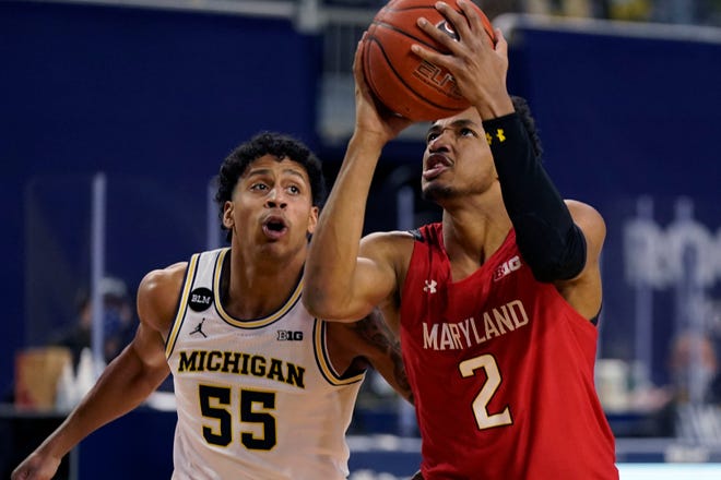 Maryland guard Aaron Wiggins (2) attempts a layup as Michigan guard Eli Brooks (55) defends during the first half.