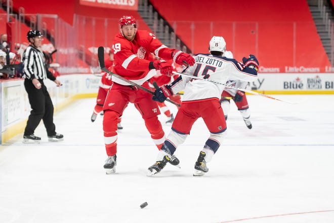 Detroit right wing Anthony Mantha and Columbus defenseman Michael Del Zotto battle for the puck in the first period.
