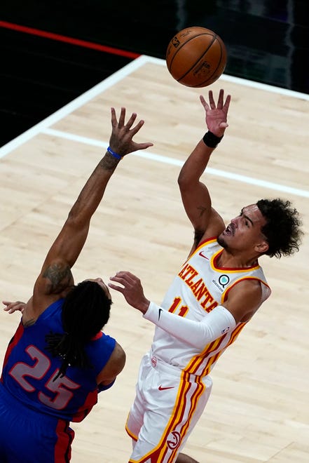 Atlanta Hawks guard Trae Young (11) shoots as Detroit Pistons guard Derrick Rose (25) defends during the first half of an NBA basketball game Wednesday, Jan. 20, 2021, in Atlanta.