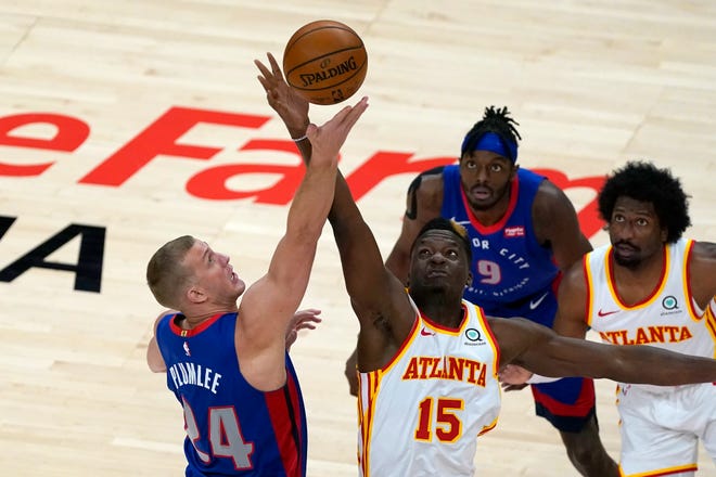 Detroit Pistons center Mason Plumlee (24) and Atlanta Hawks center Clint Capela (15) reach for the opening tip of an NBA basketball game Wednesday, Jan. 20, 2021, in Atlanta.