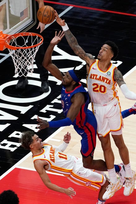Detroit Pistons forward Jerami Grant (9) has his shot blocked by Atlanta Hawks forward John Collins (20) as he drives into Trae Young (11) at the end of the second half of an NBA basketball game Wednesday, Jan. 20, 2021, in Atlanta. The Hawks won 123-115 in overtime.