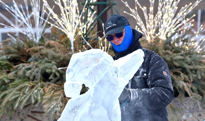 Finesse Ice owner Jeff Wolf continues to shape his ice sculpture.