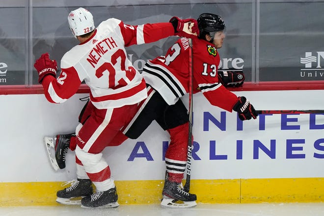 Chicago Blackhawks center Mattias Janmark, right, is checked by Detroit Red Wings left wing Patrik Nemeth during the second period.