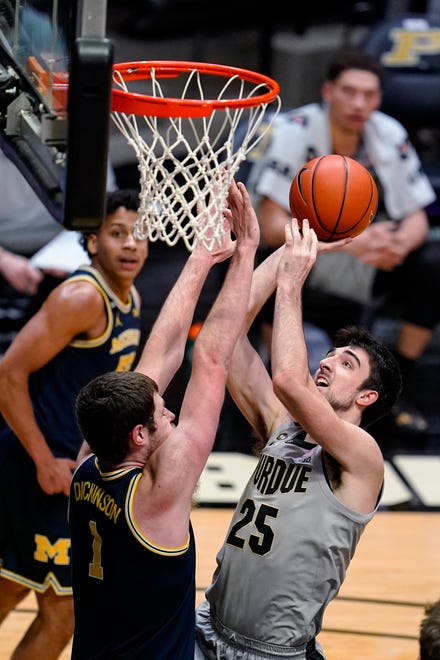 Purdue guard Ethan Morton (25) shoots over Michigan center Hunter Dickinson (1) during the second half.