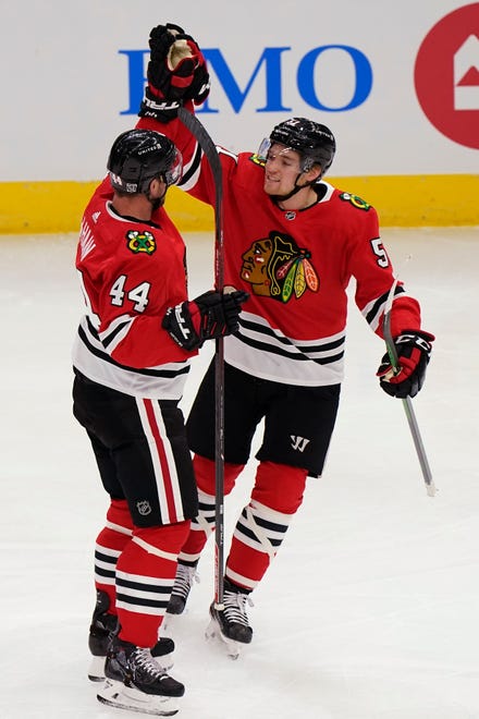 Chicago Blackhawks' Calvin de Haan, left, celebrates with Ian Mitchell after de Haan scored a goal during the second period.