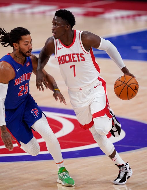 Houston Rockets guard Victor Oladipo (7) drives on Detroit Pistons guard Derrick Rose (25) during the second half of an NBA basketball game, Friday, Jan. 22, 2021, in Detroit.
