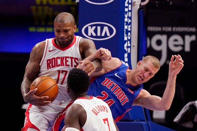 Houston Rockets forward P.J. Tucker (17) grabs the rebound as he gets tangled up with Detroit Pistons center Mason Plumlee (24) during the second half of an NBA basketball game, Friday, Jan. 22, 2021, in Detroit.