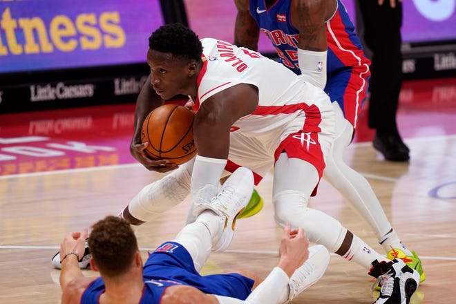 Houston Rockets guard Victor Oladipo (7) controls the ball after running into Detroit Pistons forward Blake Griffin during the second half of an NBA basketball game, Friday, Jan. 22, 2021, in Detroit.