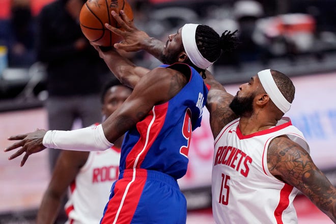 Houston Rockets center DeMarcus Cousins (15) knocks the ball away from Detroit Pistons forward Jerami Grant (9) during the first half.