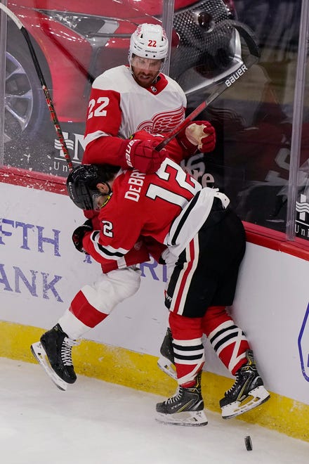 Detroit Red Wings left wing Patrik Nemeth, top, is checked by Chicago Blackhawks left wing Alex DeBrincat during the second period.