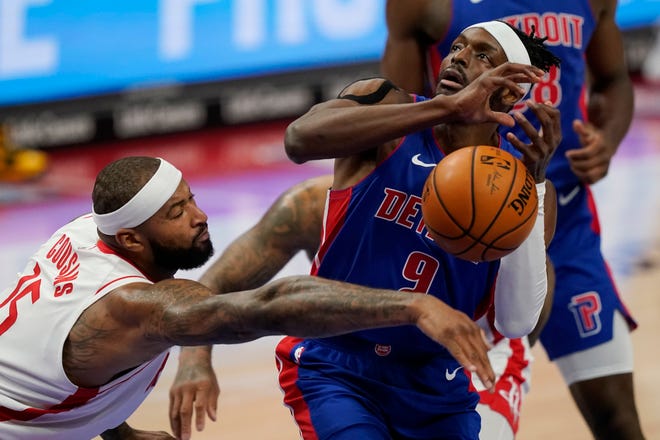 Houston Rockets center DeMarcus Cousins (15) knocks the ball away from Detroit Pistons forward Jerami Grant (9) during the first half.