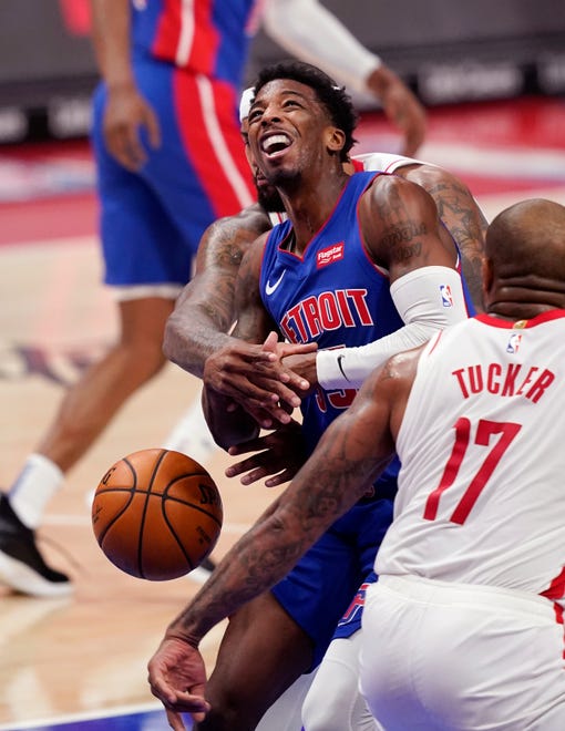 Houston Rockets center DeMarcus Cousins knocks the ball away from Detroit Pistons guard Delon Wright during the first half.