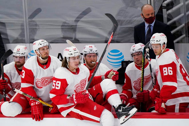 Detroit Red Wings coach Jeff Blashill and players watch during the third period. The Blackhawks won 4-1.