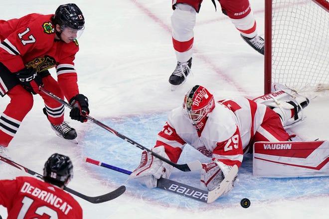 Detroit Red Wings goalie Thomas Greiss, right, blocks a shot by Chicago Blackhawks center Dylan Strome (17) during the second period of an NHL hockey game in Chicago, Friday, Jan. 22, 2021. (AP Photo/Nam Y. Huh)