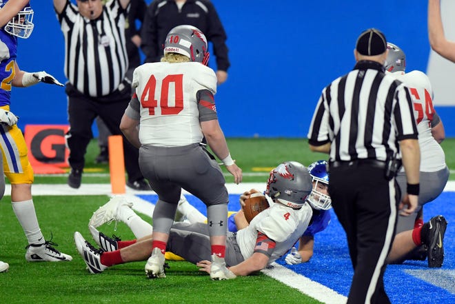 Frankenmuth quarterback Davin Reif (4) dives into the end zone for a touchdown against Grand Rapids Catholic Central in the third quarter.