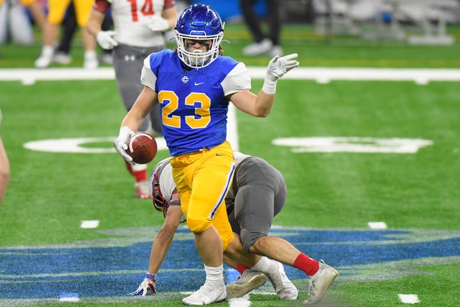 Grand Rapids Catholic Central running back Nick Hollern reacts after making a first down against Frankenmuth in the first half of a Division 5 football final held at Ford Field in Detroit, Saturday, Jan. 23, 2021.
