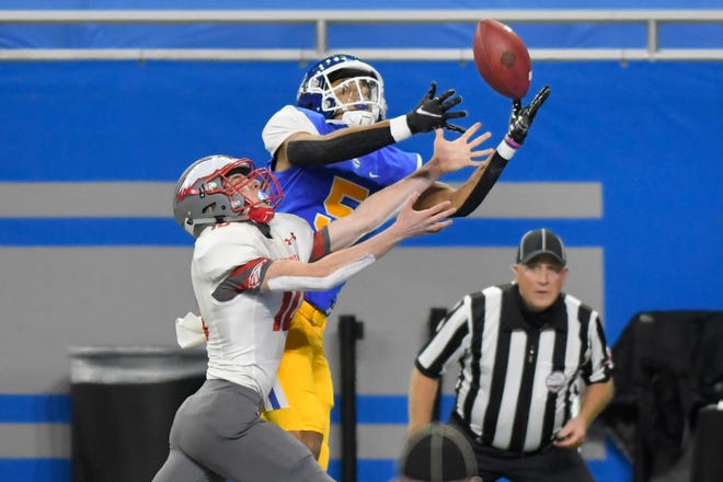Grand Rapids Catholic Central wide receiver Jace Williams, right, hauls in the pass, but is ruled out of bounds as Frankenmuth defensive back Samuel McKenzie defends him in the first half.