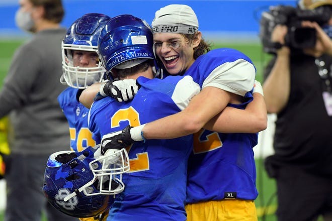 Grand Rapids Catholic Central's John Passinault, left, and Jack Krajewski celebrate after defeating Frankenmuth 48-21 in a Division 5 football final held at Ford Field in Detroit, Saturday, Jan. 23, 2021.