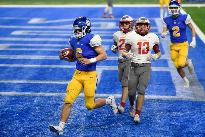 Grand Rapids Catholic Central quarterback Joey Silveri, bottom, rushes into the end zone for a touchdown against Frankenmuth in the third quarter.