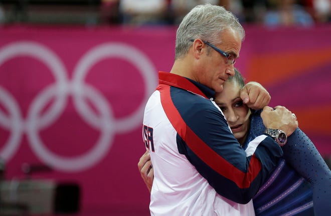 U.S. gymnast Jordyn Wieber is consoled by head coach John Geddert after her performance during the artistic gymnastics women's floor exercise final at the 2012 Summer Olympics, Tuesday Aug. 7, 2012, in London.
